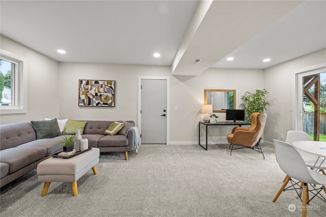 carpeted living room featuring plenty of natural light