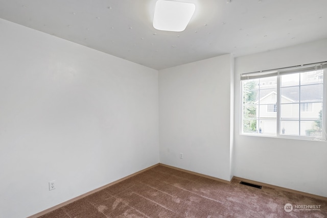 unfurnished room featuring carpet floors