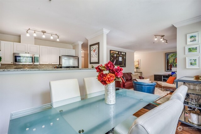 dining room featuring ornamental molding and decorative columns