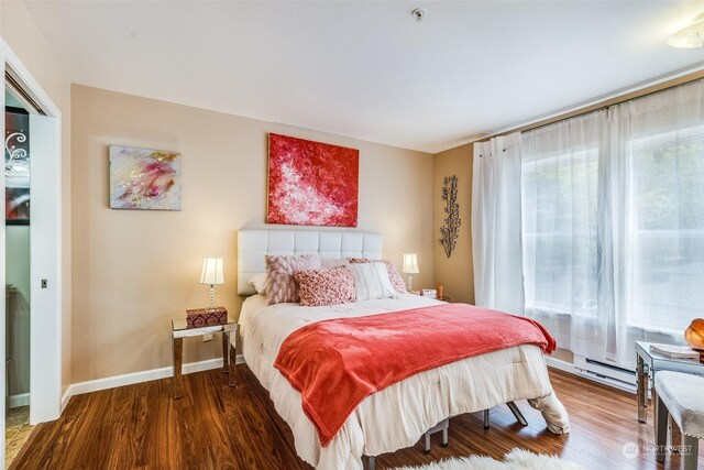 bedroom with wood-type flooring and a baseboard radiator