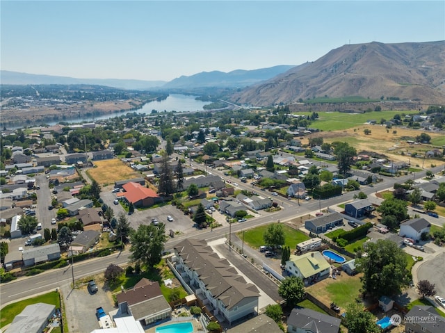 drone / aerial view with a water and mountain view