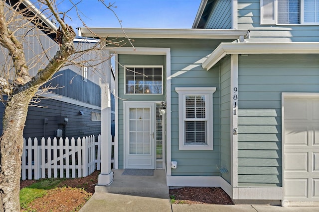 view of exterior entry with a garage