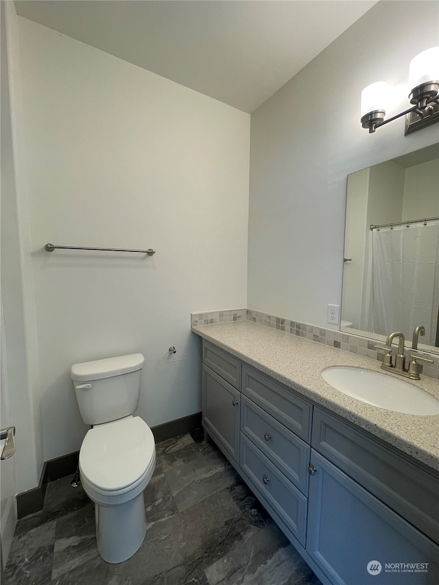 bathroom featuring vanity and toilet