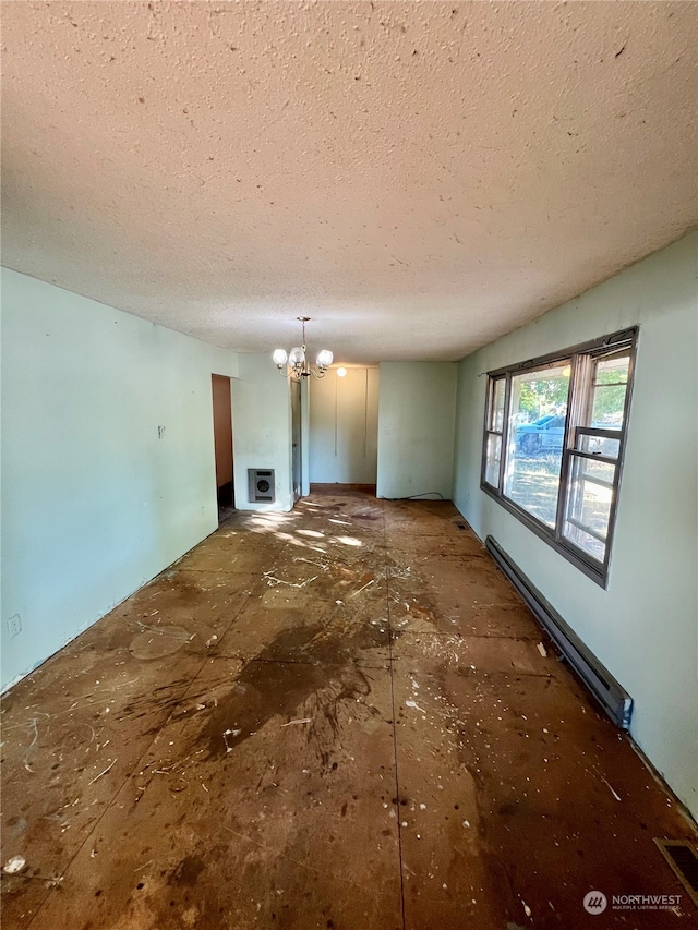 unfurnished room featuring an inviting chandelier, a baseboard radiator, and a textured ceiling