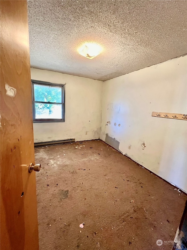 carpeted spare room with a textured ceiling