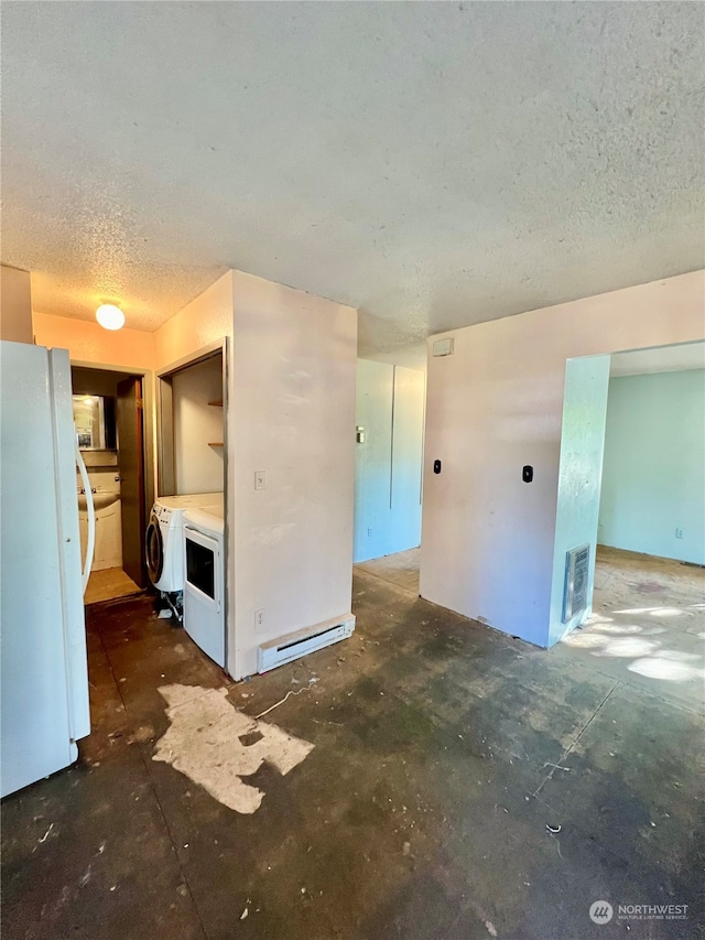 spare room featuring washer / clothes dryer and a textured ceiling