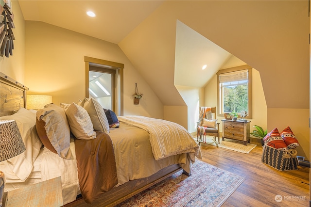 bedroom featuring vaulted ceiling and hardwood / wood-style flooring