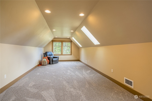 bonus room with carpet and lofted ceiling with skylight