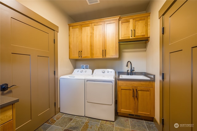 laundry area featuring cabinets, independent washer and dryer, and sink