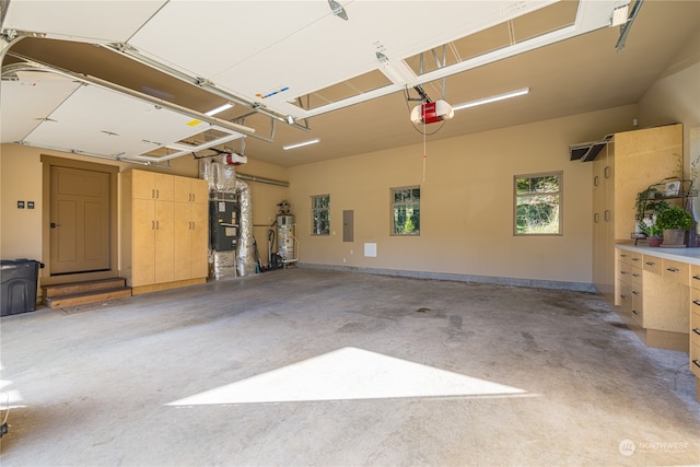 garage with water heater, a garage door opener, heating unit, and electric panel