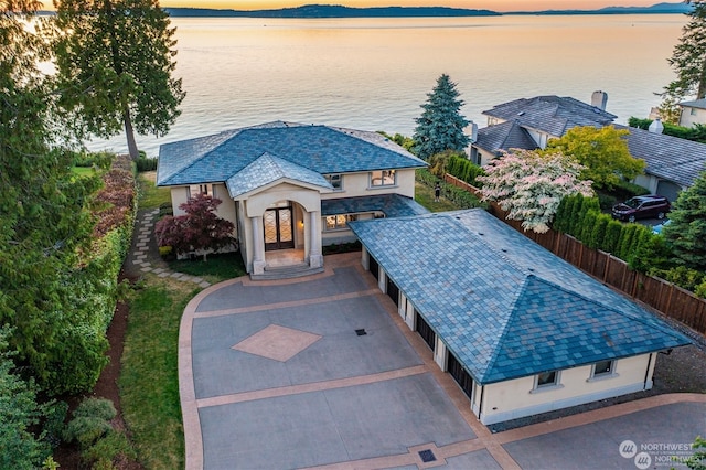 view of front of house with a water view