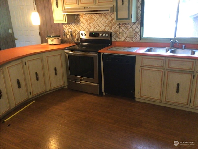 kitchen with black dishwasher, dark hardwood / wood-style flooring, cream cabinets, sink, and stainless steel electric range oven