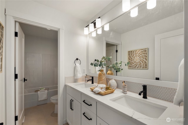 full bathroom with backsplash, vanity, tile patterned flooring, toilet, and tiled shower / bath