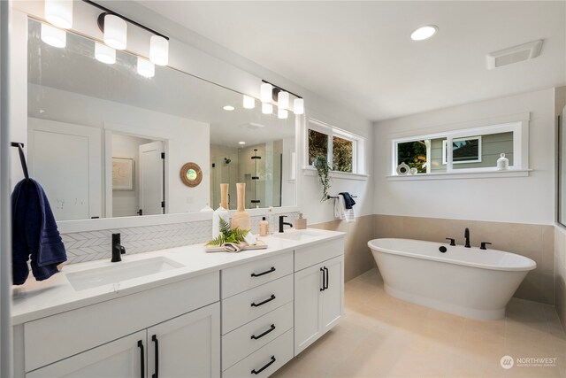 bathroom with tile walls, vanity, and independent shower and bath