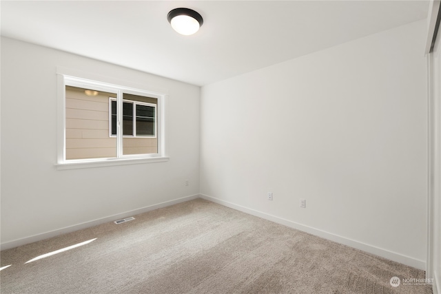 unfurnished room with carpet flooring