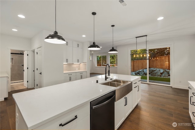 kitchen featuring white cabinets, a kitchen island with sink, pendant lighting, and stainless steel dishwasher