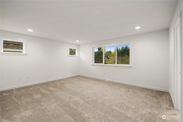 interior space with recessed lighting, baseboards, and light colored carpet