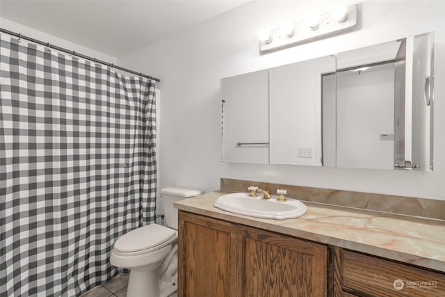 bathroom featuring tile patterned flooring, vanity, and toilet