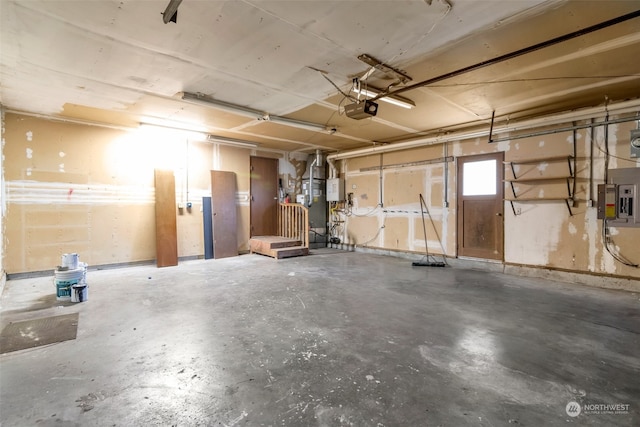 garage with a garage door opener and electric panel