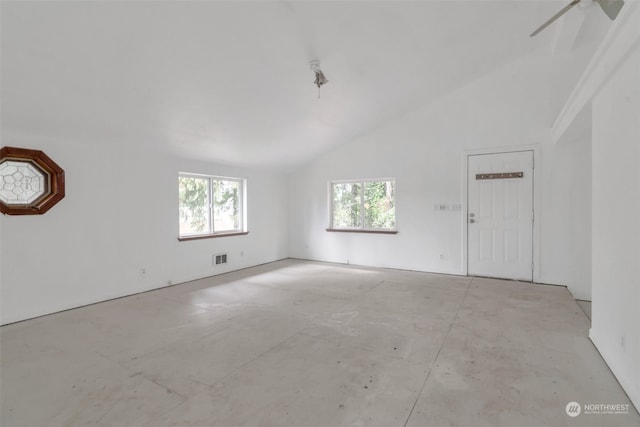 spare room featuring vaulted ceiling and ceiling fan