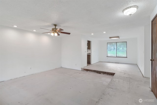 unfurnished room featuring ceiling fan and a textured ceiling