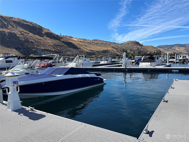 view of dock featuring a water and mountain view