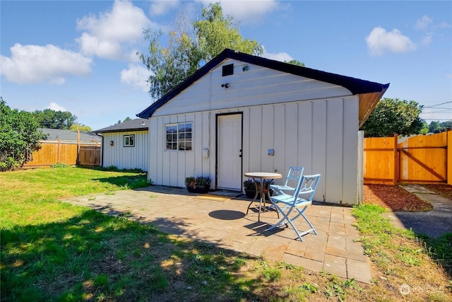 view of outbuilding featuring a fenced backyard and a gate