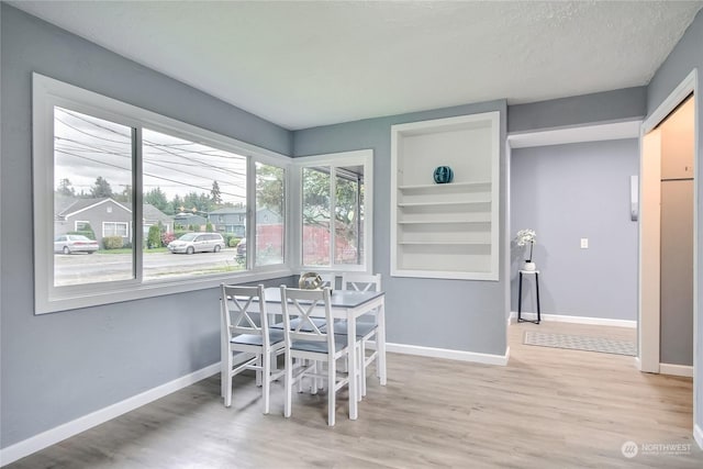 dining area featuring baseboards and wood finished floors