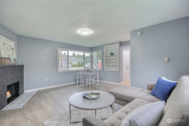 living room featuring a textured ceiling and light hardwood / wood-style flooring