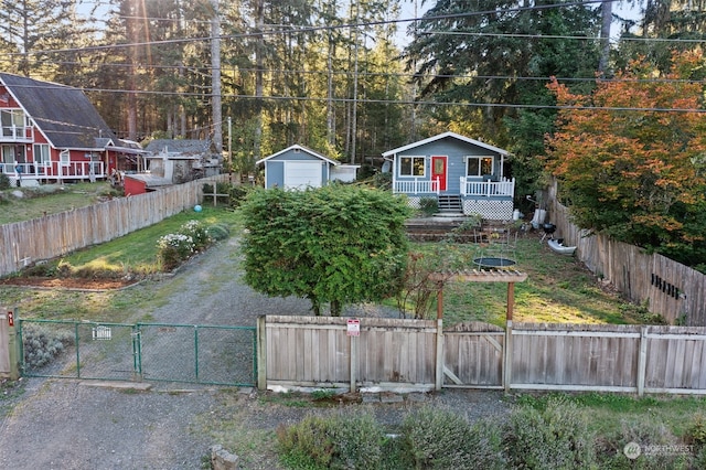 view of front of property with a garage and an outbuilding