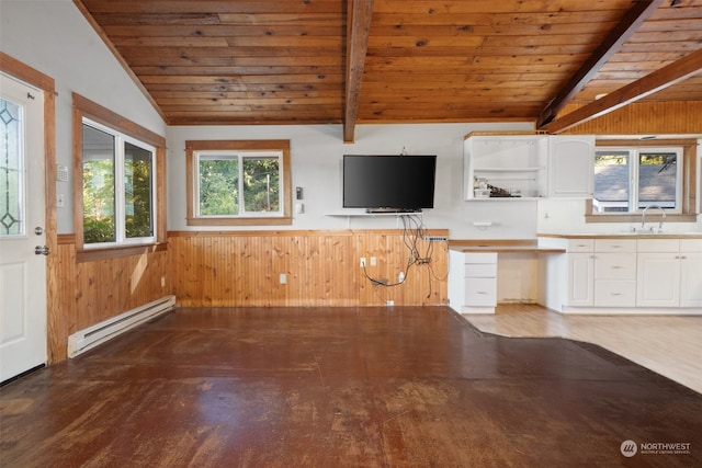 kitchen featuring white cabinets, wooden walls, a baseboard heating unit, lofted ceiling with beams, and hardwood / wood-style floors