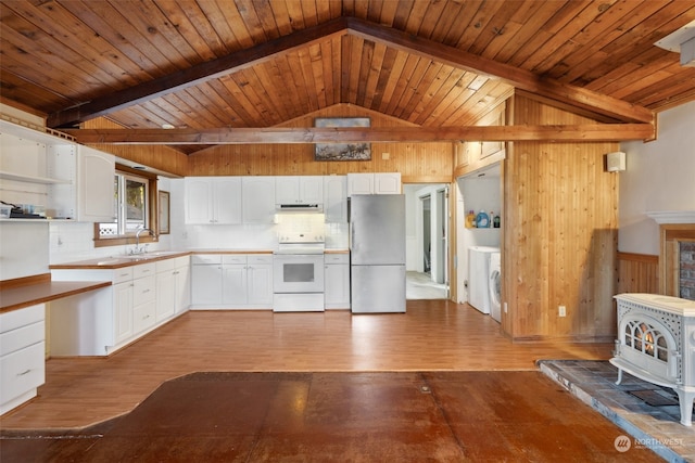 kitchen with white cabinetry, stainless steel refrigerator, light wood-type flooring, white electric range, and wooden walls