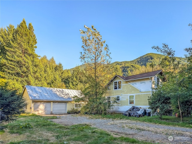 view of front of house with a mountain view and an outdoor structure