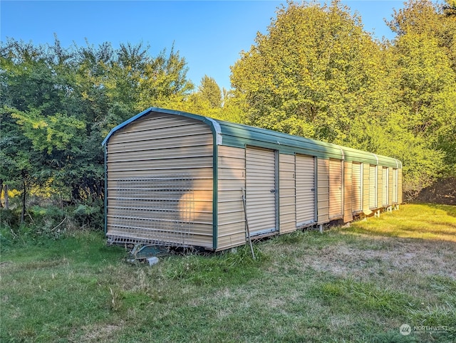 view of outbuilding with a lawn