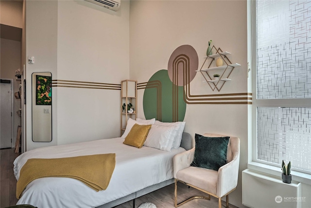 bedroom with wood-type flooring and an AC wall unit