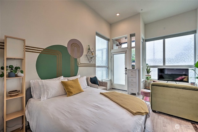 bedroom featuring light hardwood / wood-style flooring and multiple windows