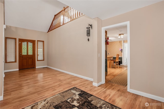 entryway with vaulted ceiling, ceiling fan, and hardwood / wood-style floors