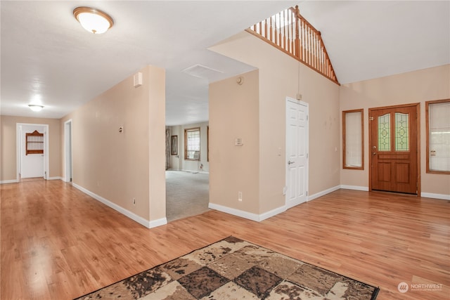 foyer featuring vaulted ceiling and hardwood / wood-style floors