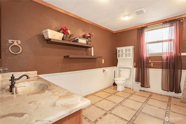 bathroom with ornamental molding, vanity, tile patterned flooring, and toilet