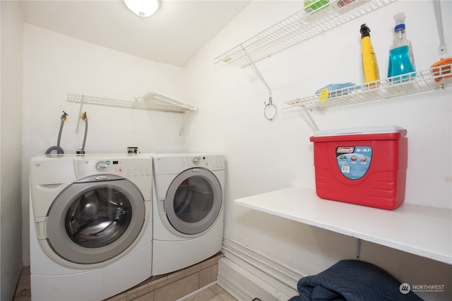 washroom with tile patterned flooring and washing machine and dryer