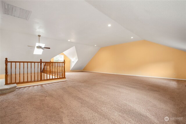 additional living space with carpet, lofted ceiling, and ceiling fan