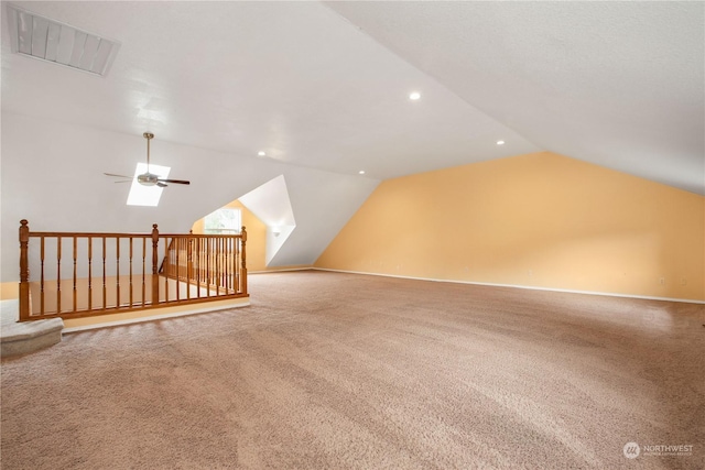 additional living space with vaulted ceiling, recessed lighting, a ceiling fan, carpet floors, and visible vents