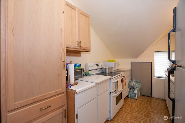 kitchen featuring light brown cabinetry, light countertops, white appliances, and vaulted ceiling