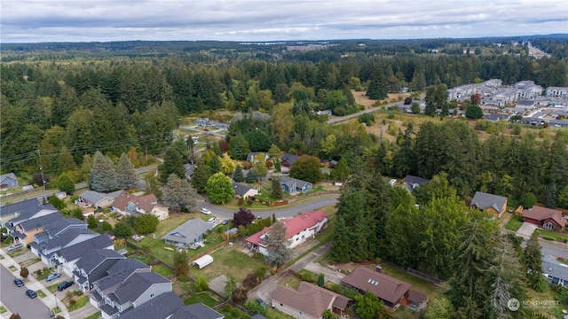 aerial view featuring a forest view and a residential view
