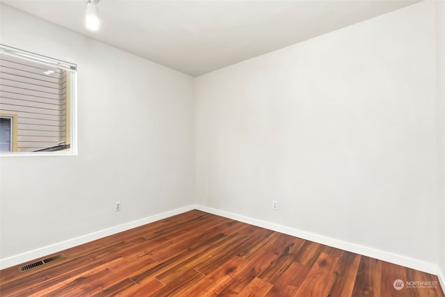 unfurnished room featuring hardwood / wood-style flooring