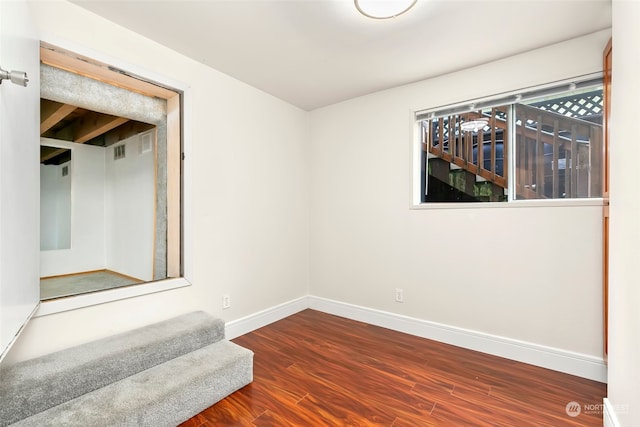 spare room with hardwood / wood-style flooring