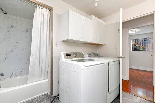 washroom featuring dark hardwood / wood-style flooring and washing machine and clothes dryer