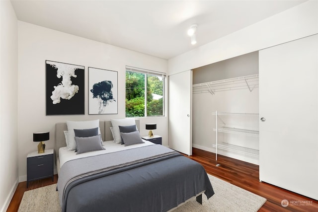 bedroom featuring a closet and dark hardwood / wood-style floors