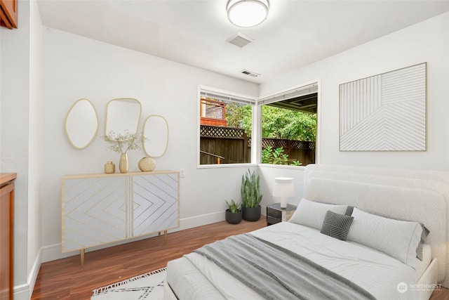 bedroom with wood-type flooring