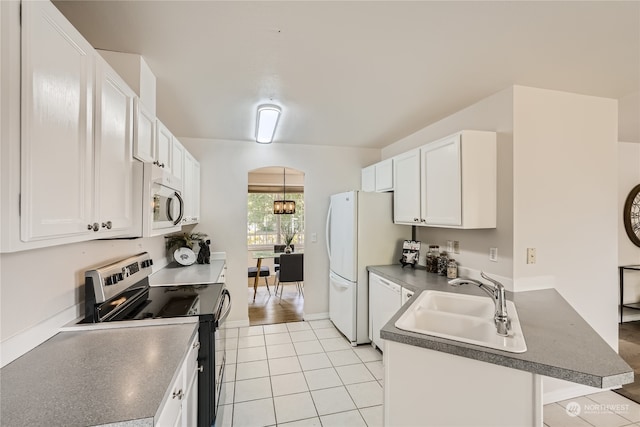 kitchen featuring a kitchen bar, sink, white appliances, and white cabinetry